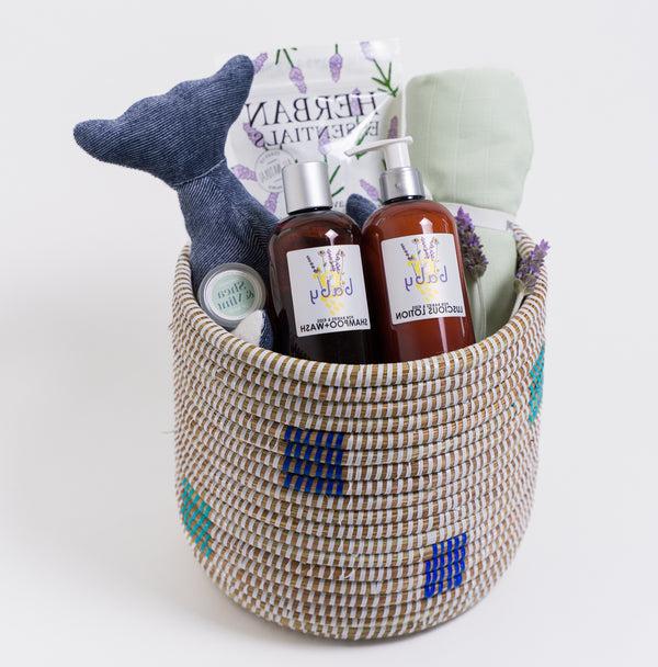 Fair trade woven basket filled with baby bedtime accessories